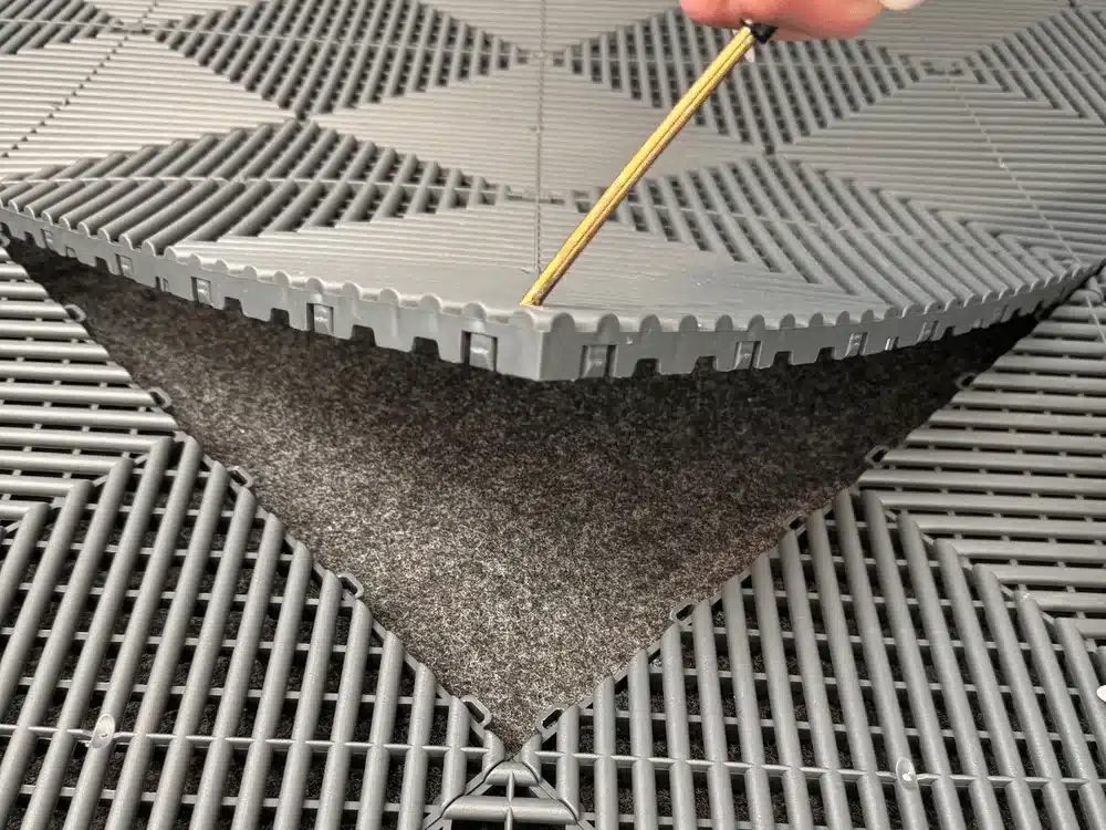 Mit dem Performance-Floor-Bodenöffner wird eine einzelne Klickfliese mitten in der Fläche angehoben